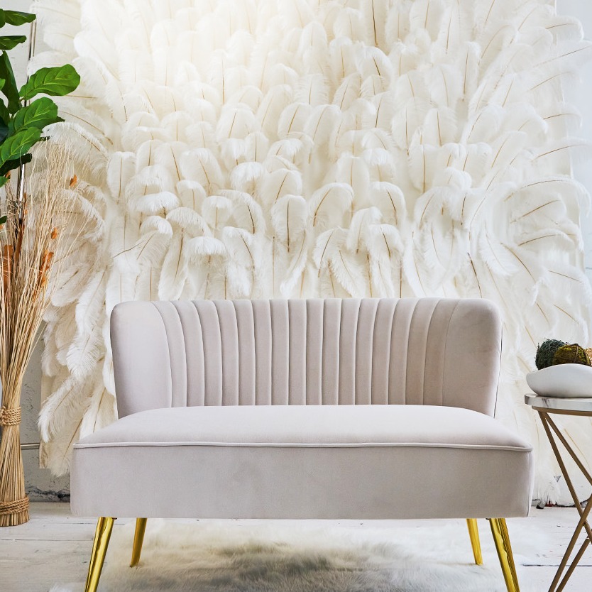 The Blush Den feather wall and velvet loveseat